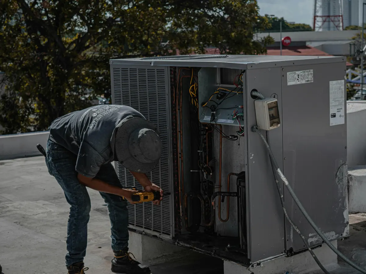 A professional repairing an air condition case